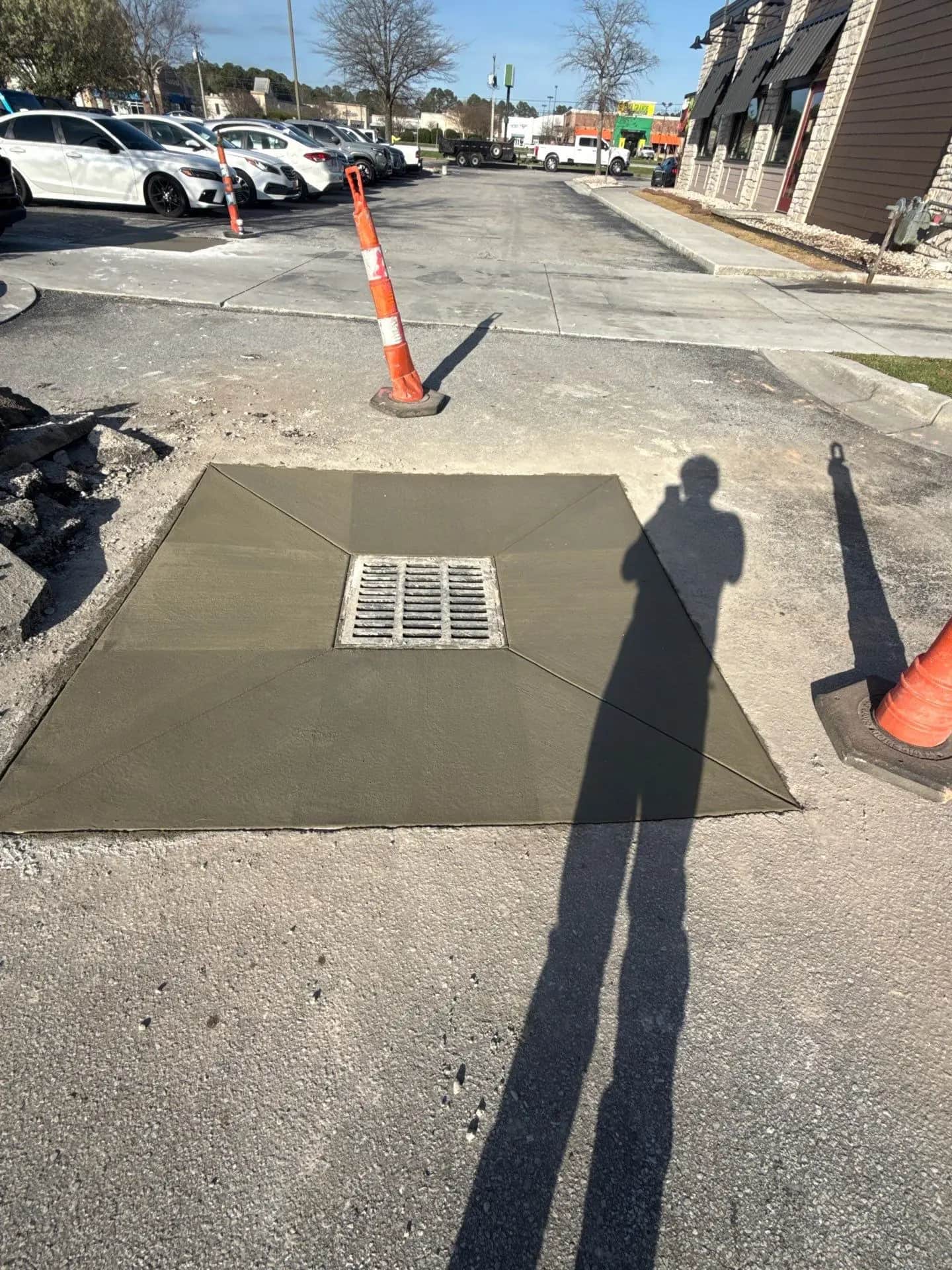 Crown Paving crew rebuilding a catch basin in a parking lot