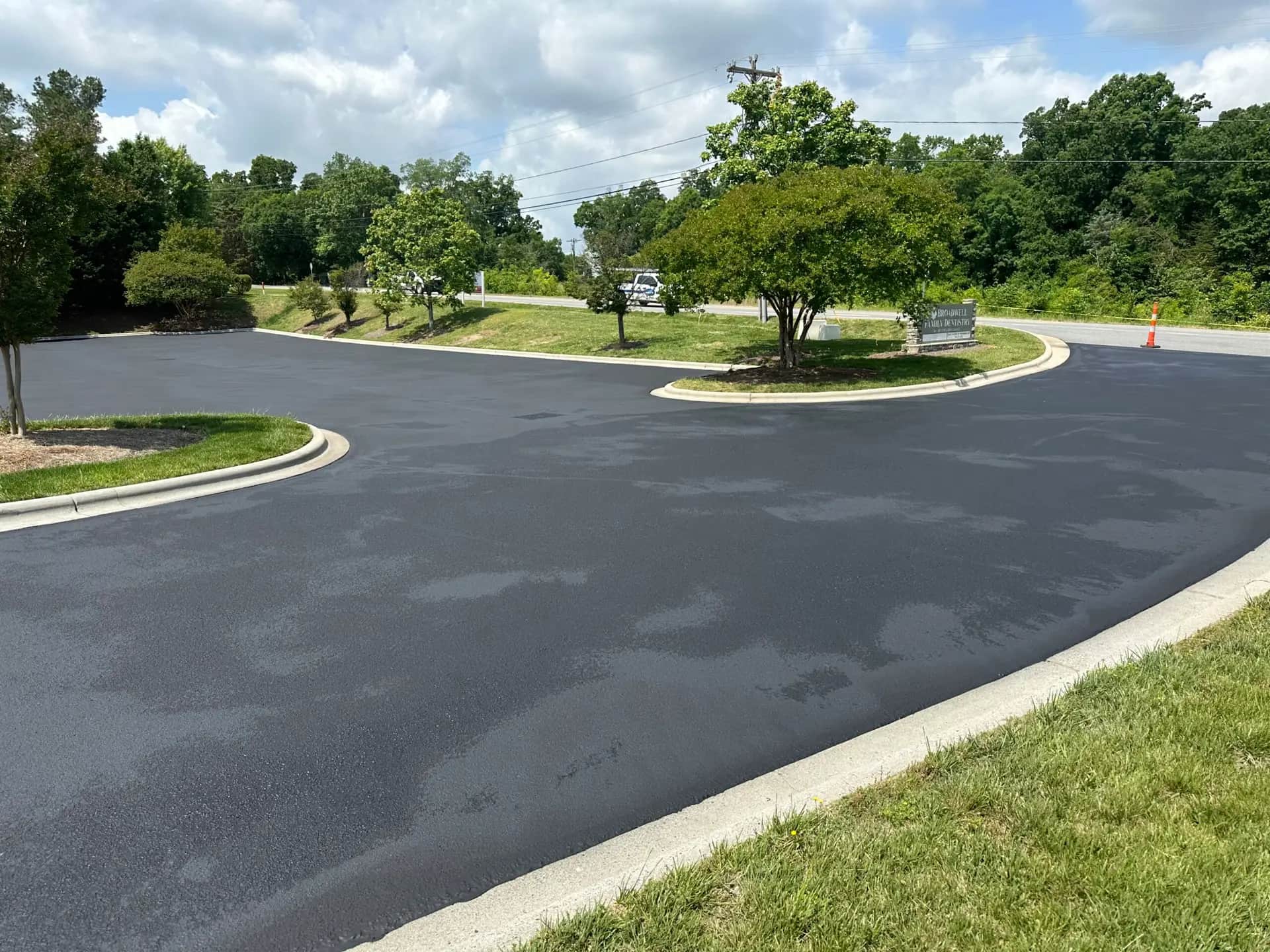 Freshly seal coated parking lot at a family dentistry practice in Kannapolis, NC