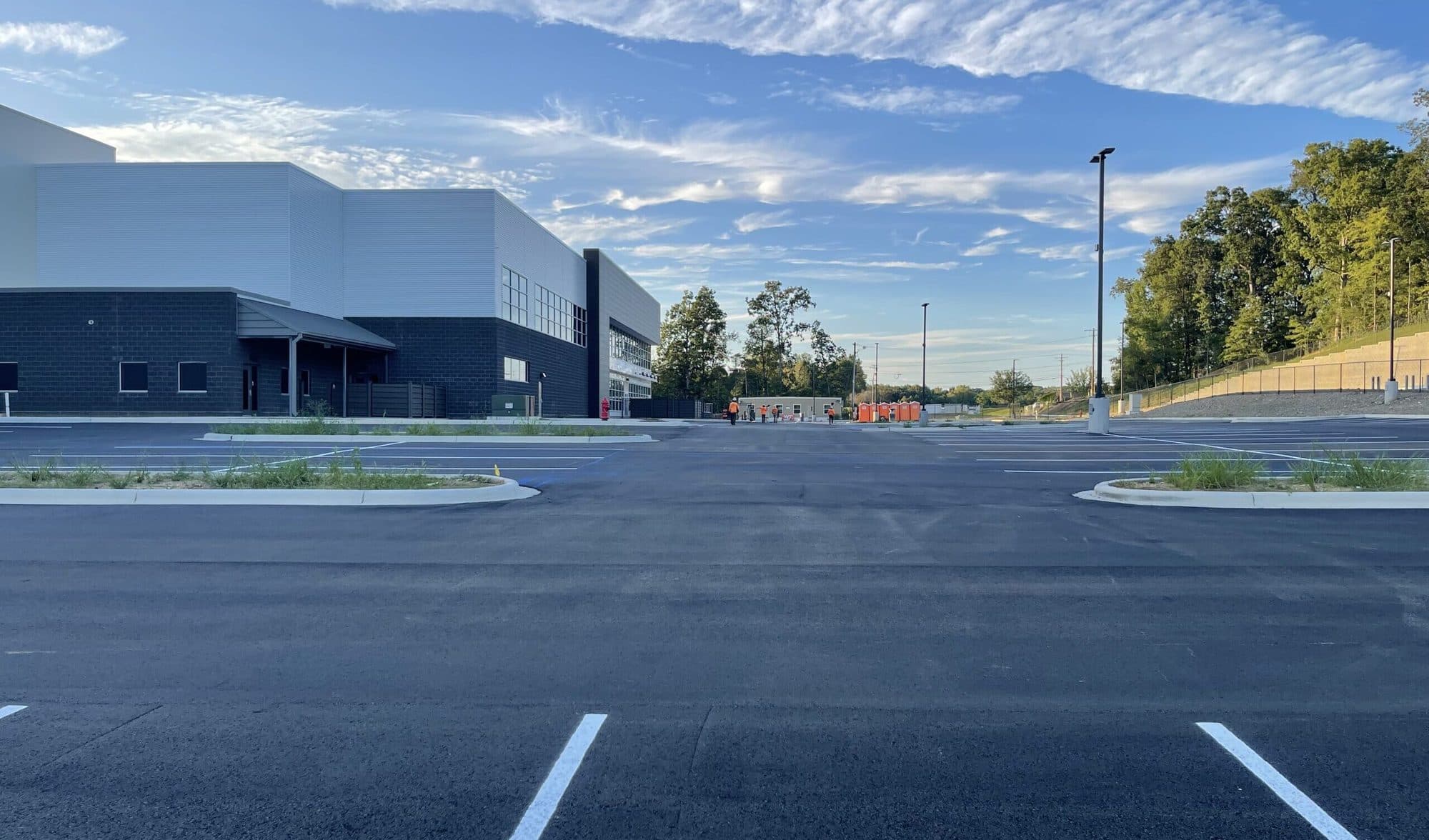 New asphalt parking lot at a distribution facility, freshly striped