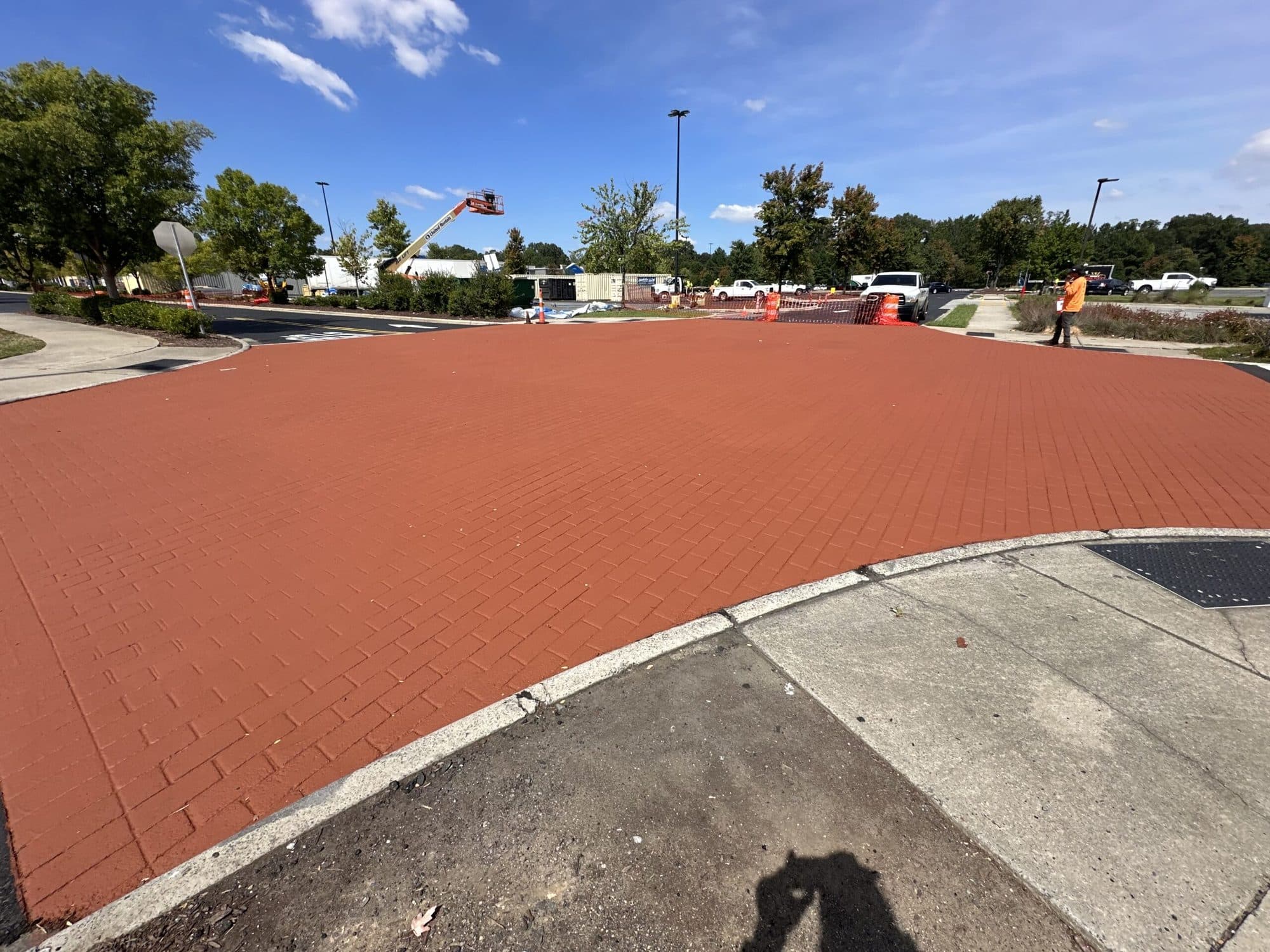Stamped red brick crosswalk installed at a shopping center entrance