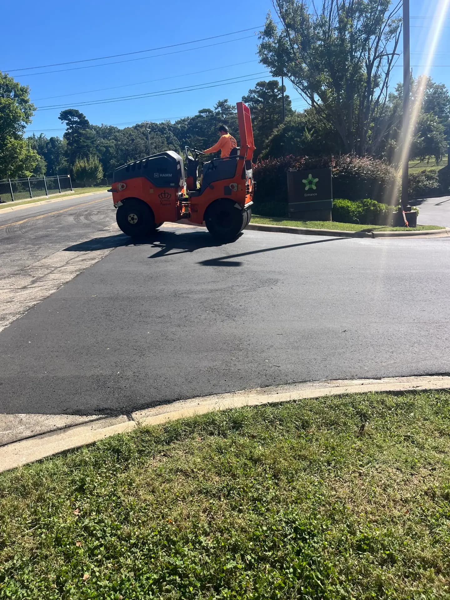 Roller compacting a completed asphalt patch