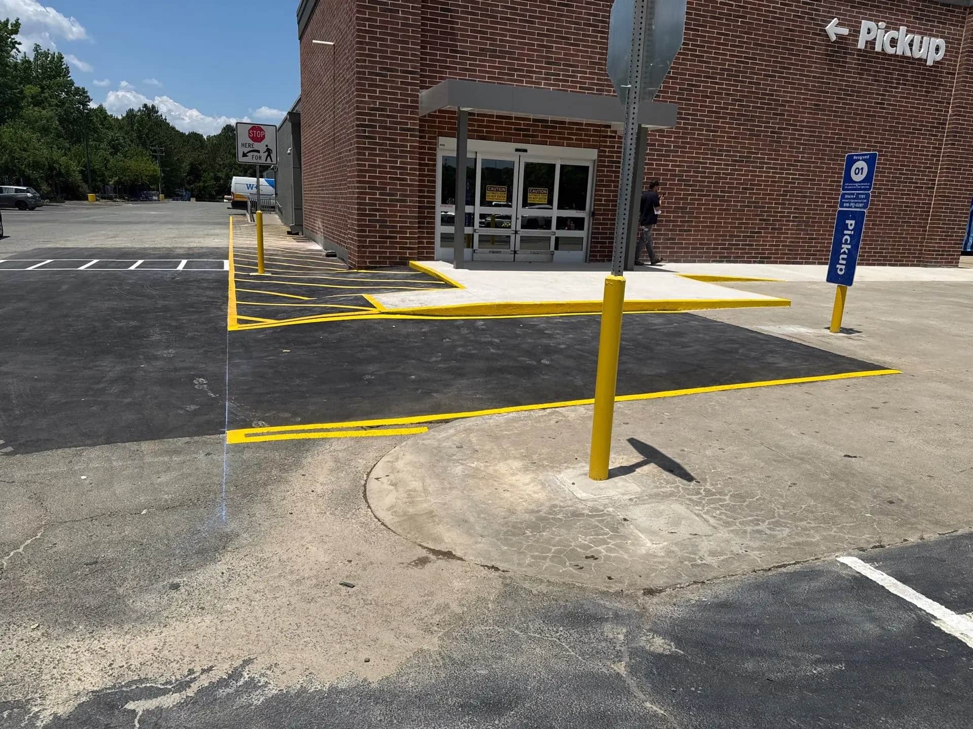Asphalt patch repair in progress at a Walmart lot in Hillsborough