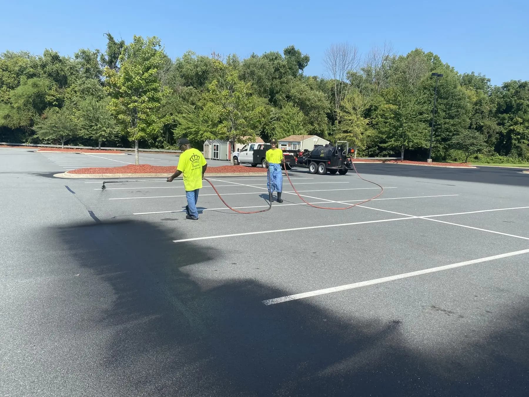 Crew applying seal coat to the parking area