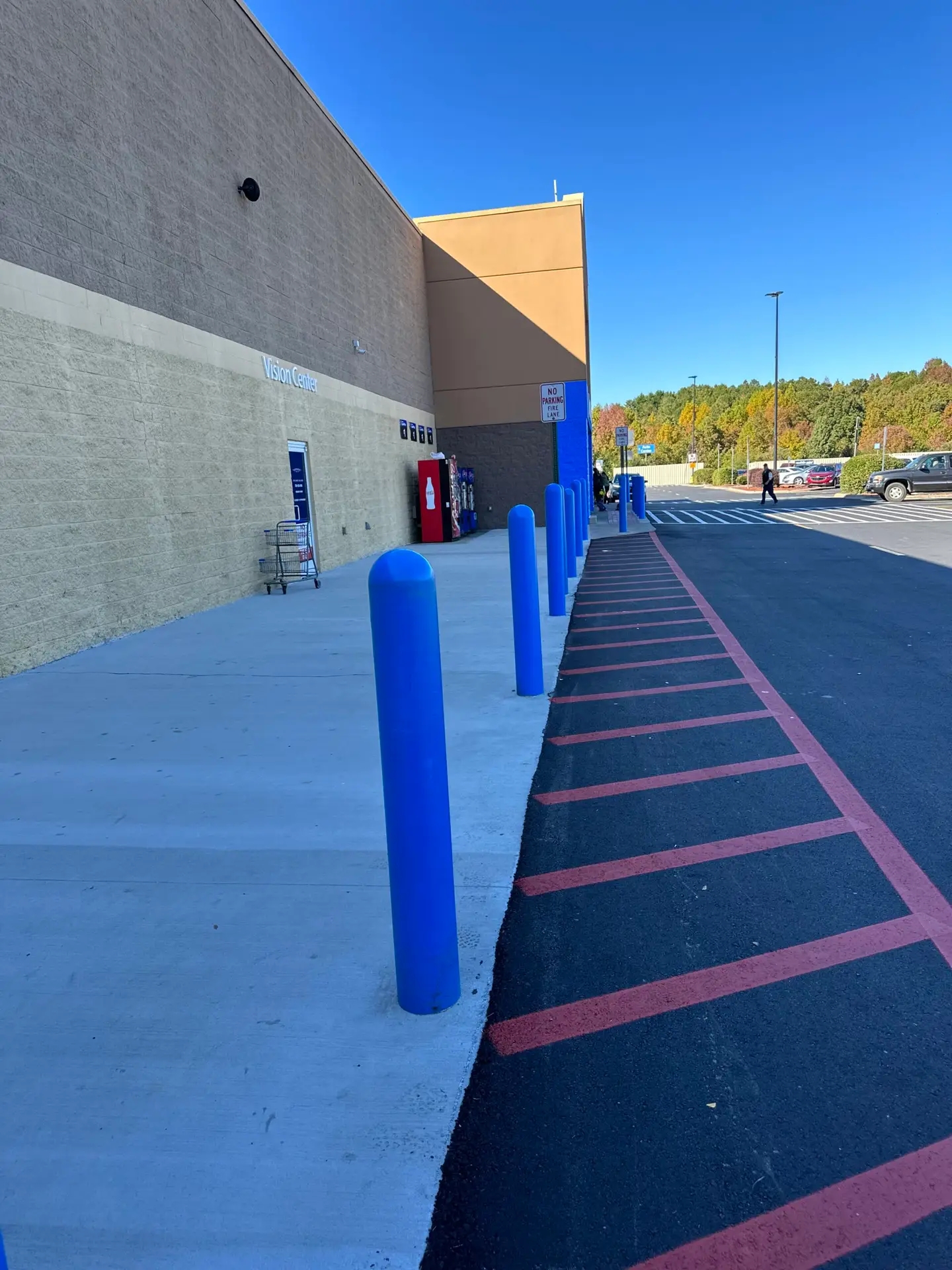 Bollards installed and painted at a storefront entrance