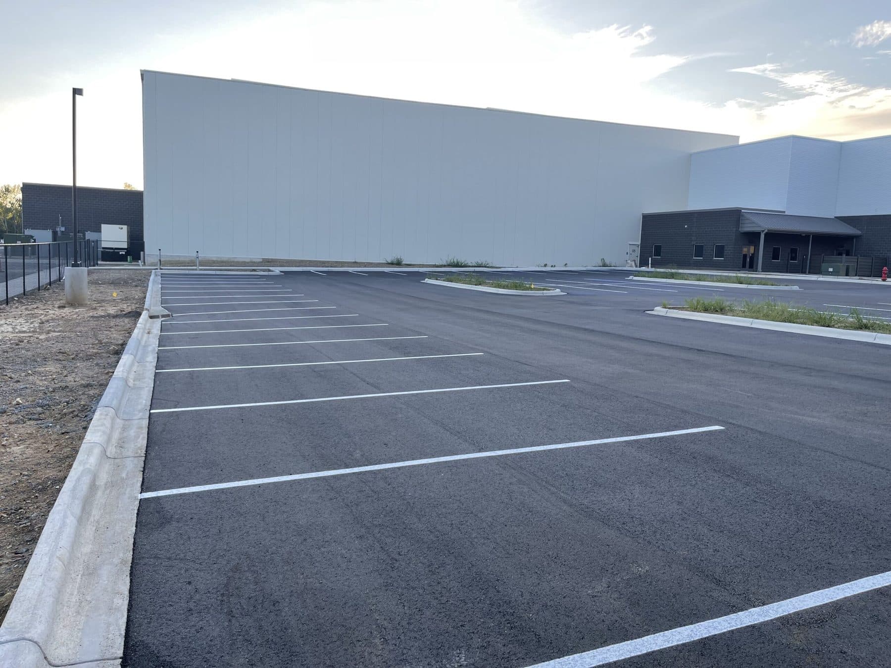 Completed commercial parking lot, freshly paved and striped