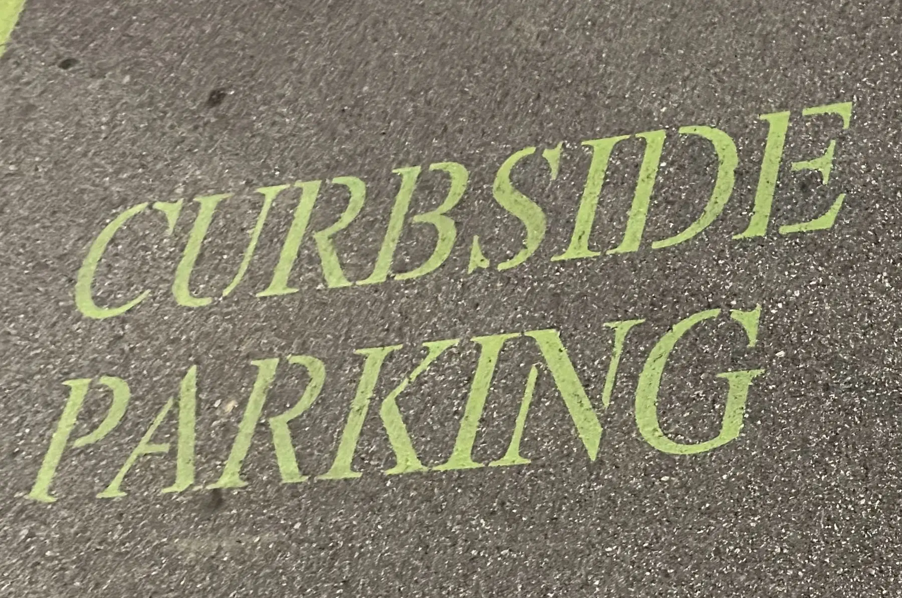 Curbside parking stencil painted on a commercial lot