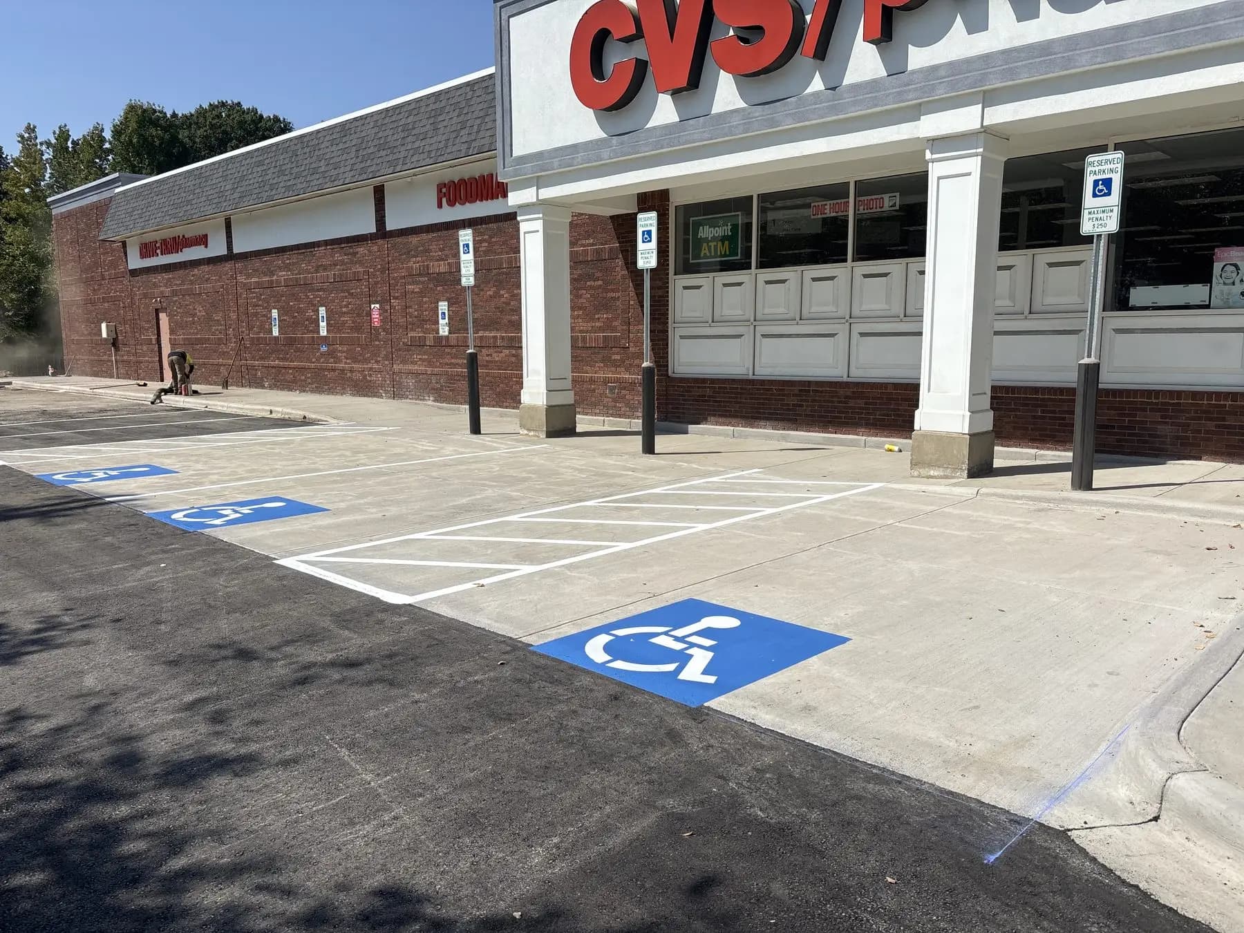 Accessible stalls and access aisle marked outside a pharmacy