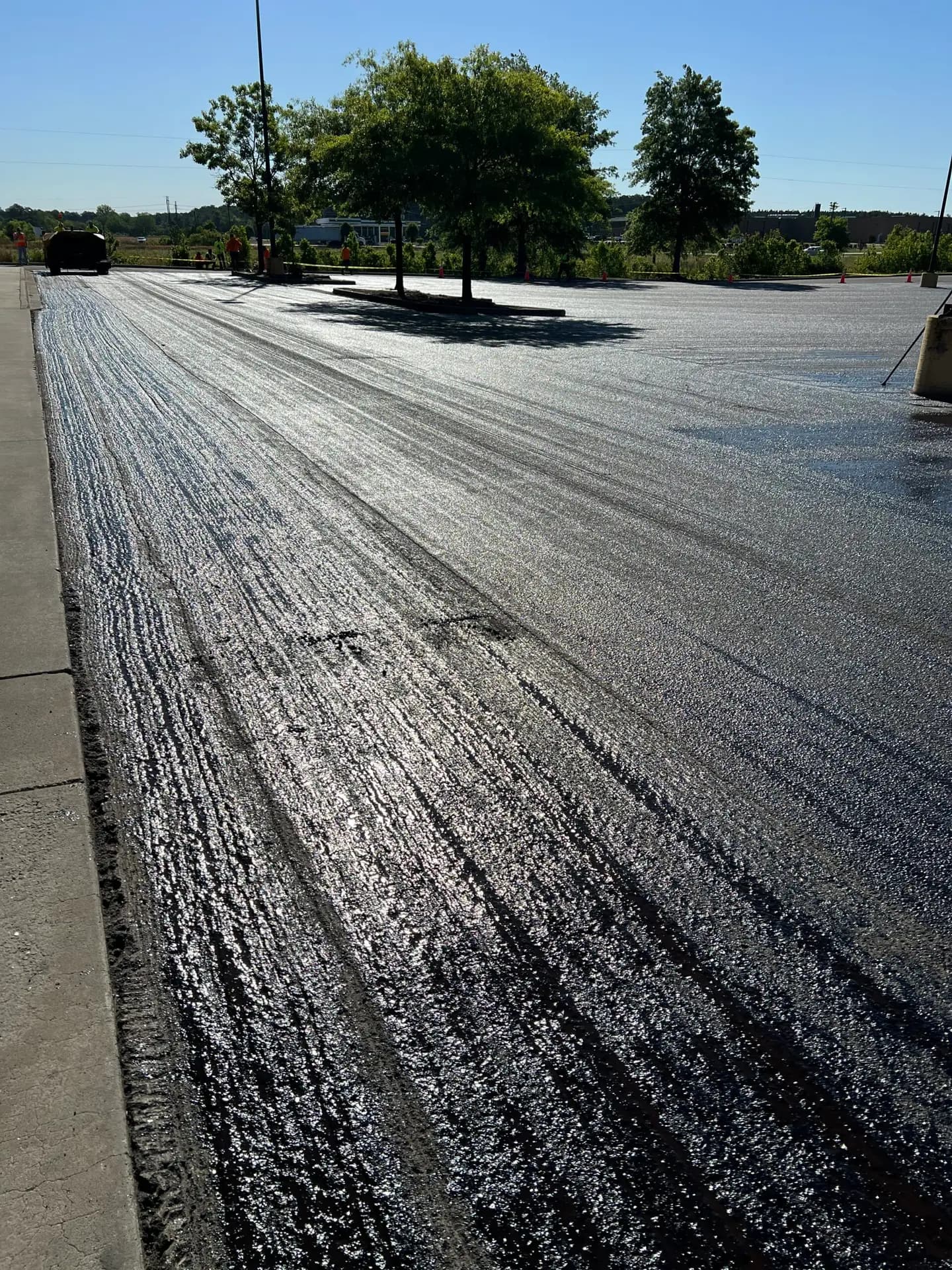 Crown Paving crew laying asphalt on a commercial lot in North Carolina