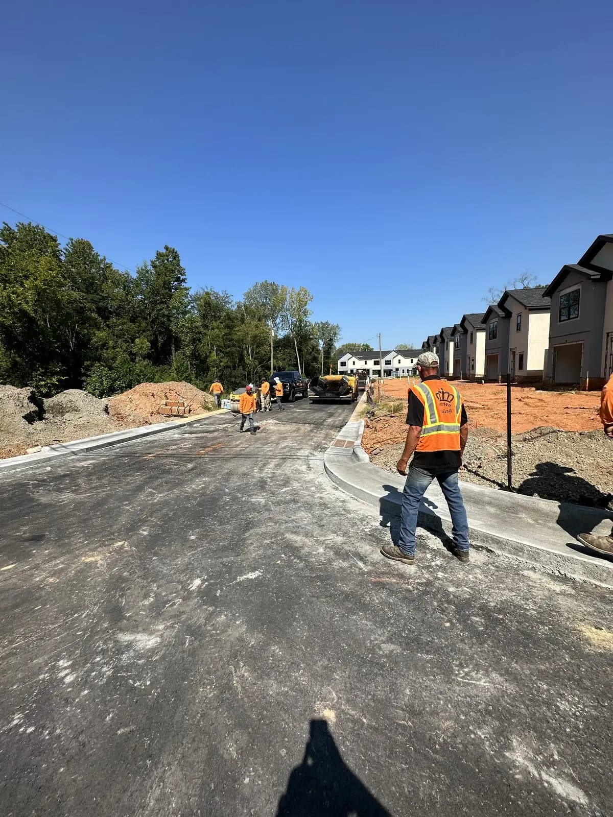Crew installing new asphalt roadway