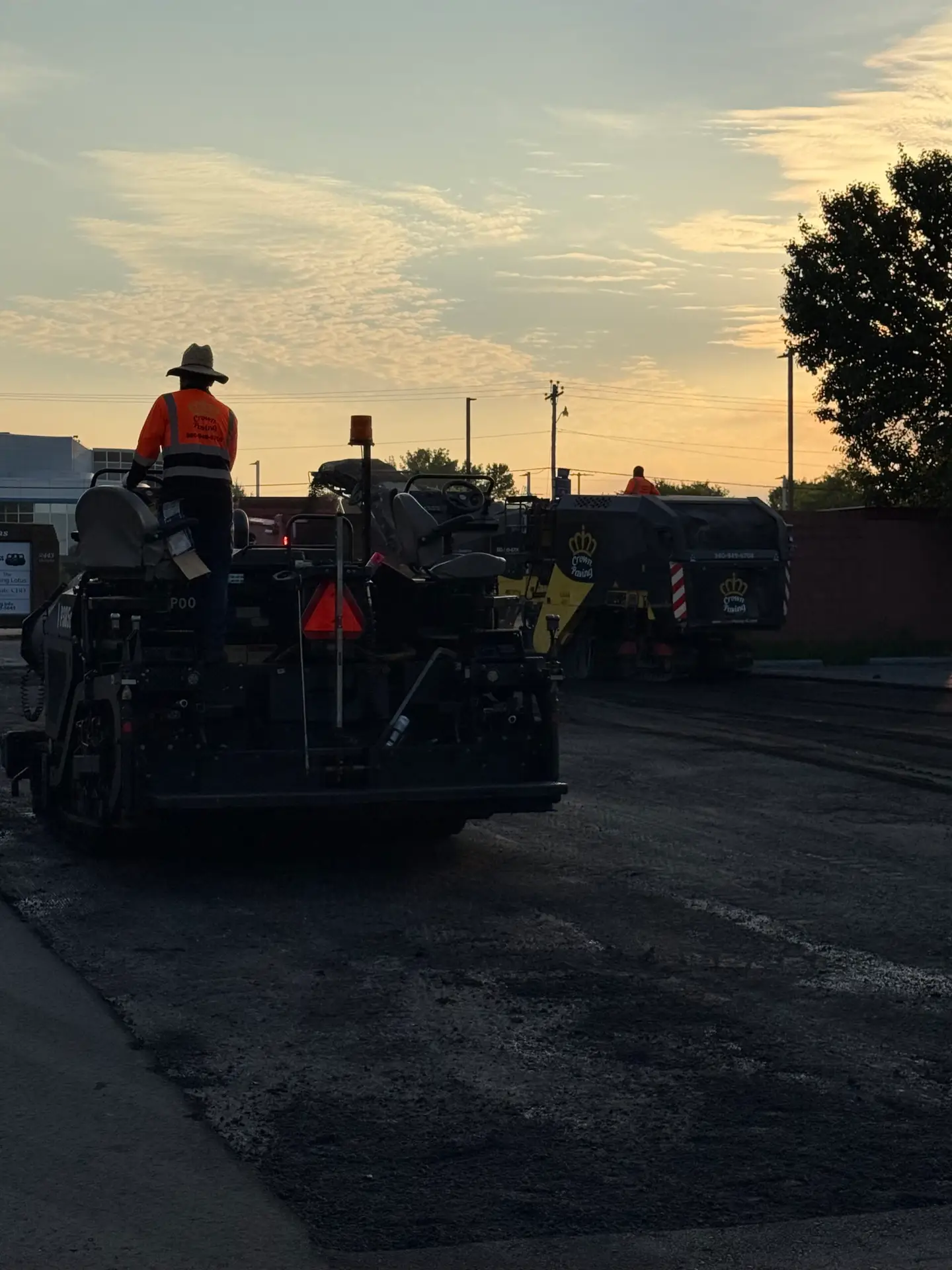 Paver laying the surface course over the binder layer