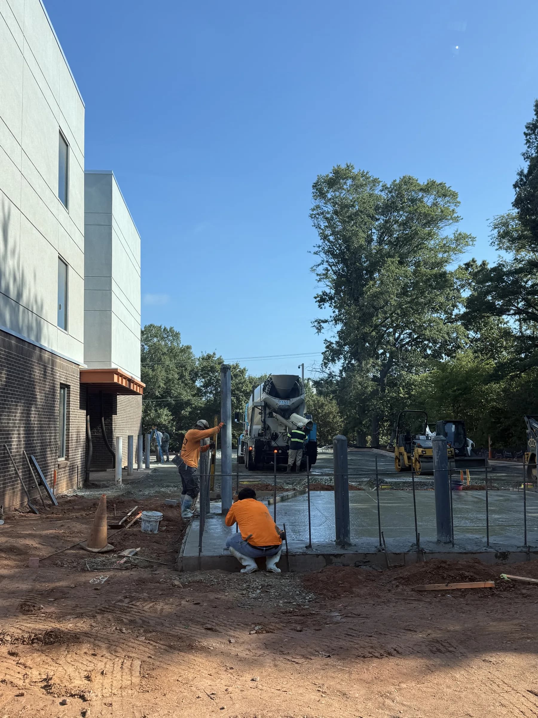 Concrete being placed around bollard posts at a self-storage facility