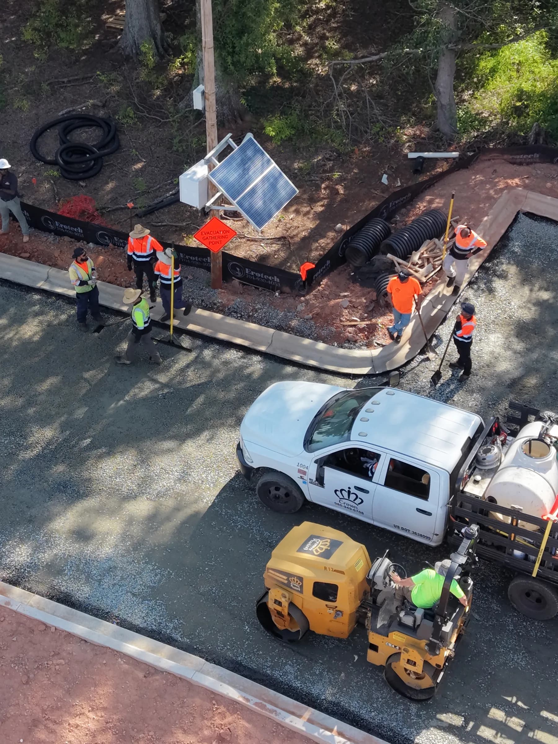 Crown Paving crew and rollers compacting a new asphalt mat at a self-storage facility
