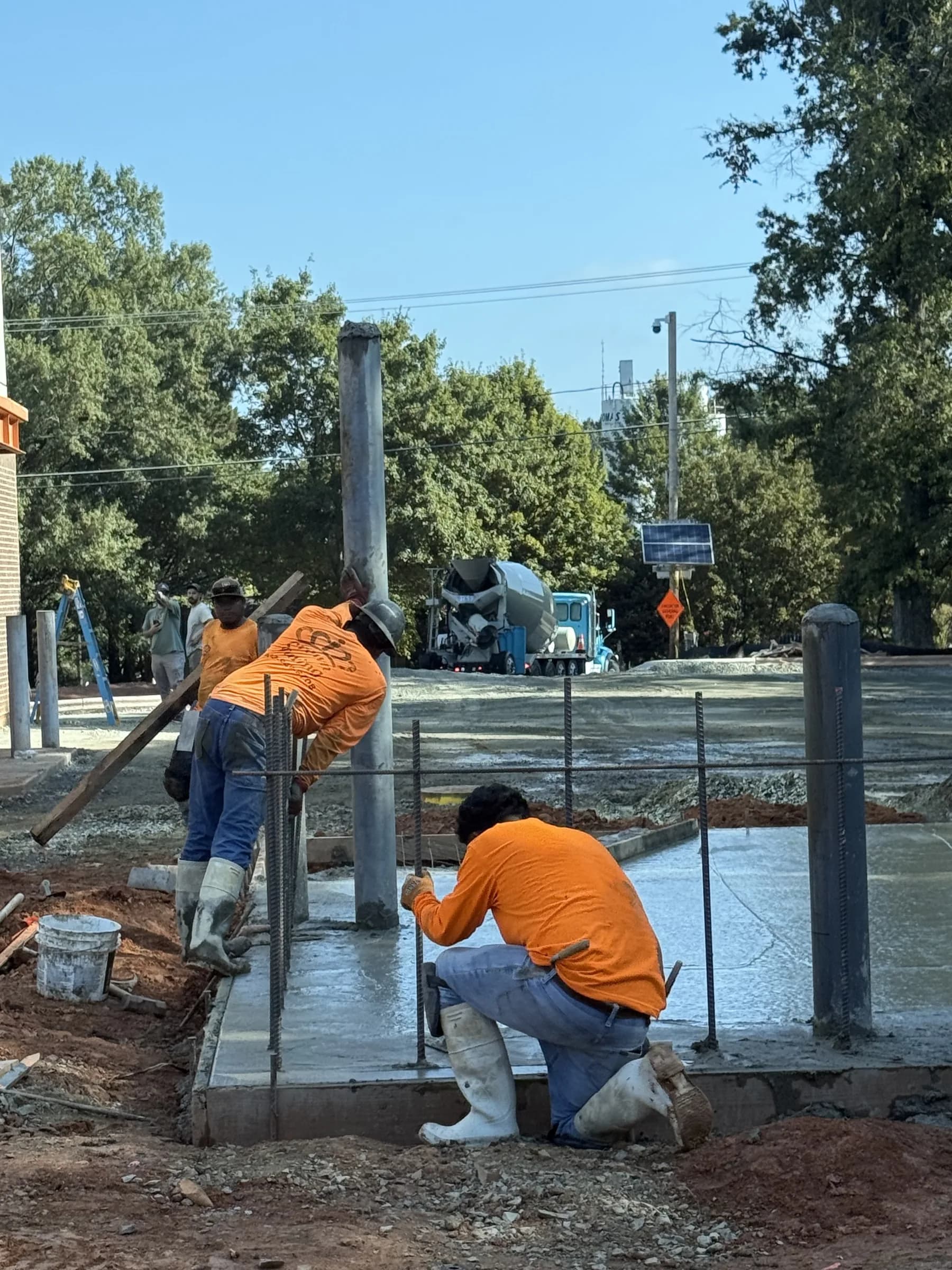 Crown Paving crew finishing new curb and flatwork moments after the pour