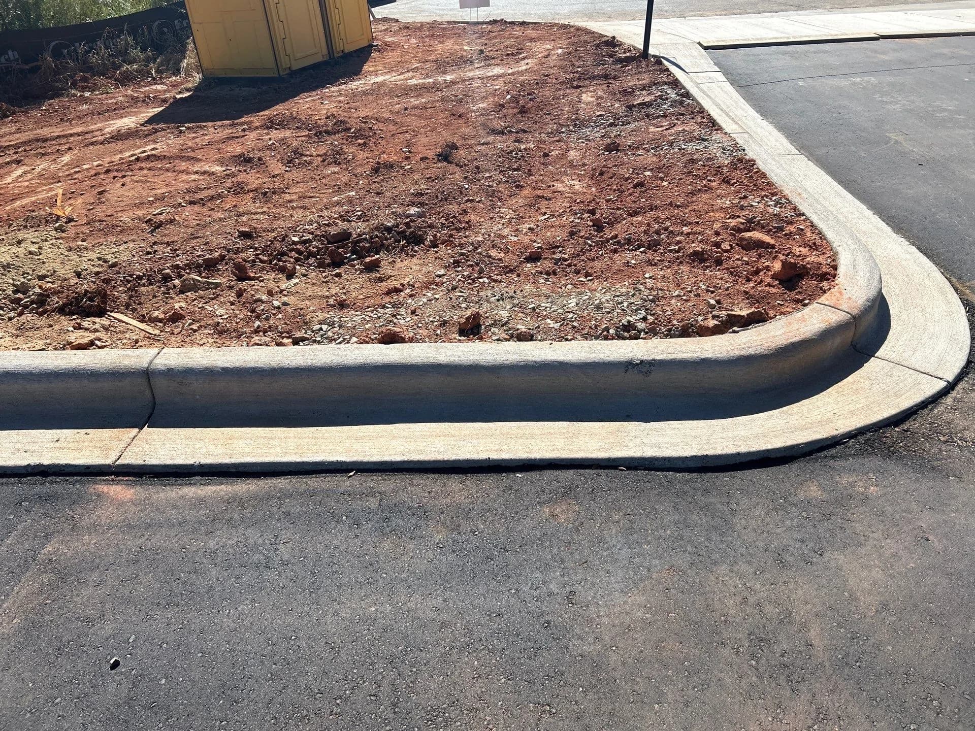 New curb and gutter set against freshly laid asphalt