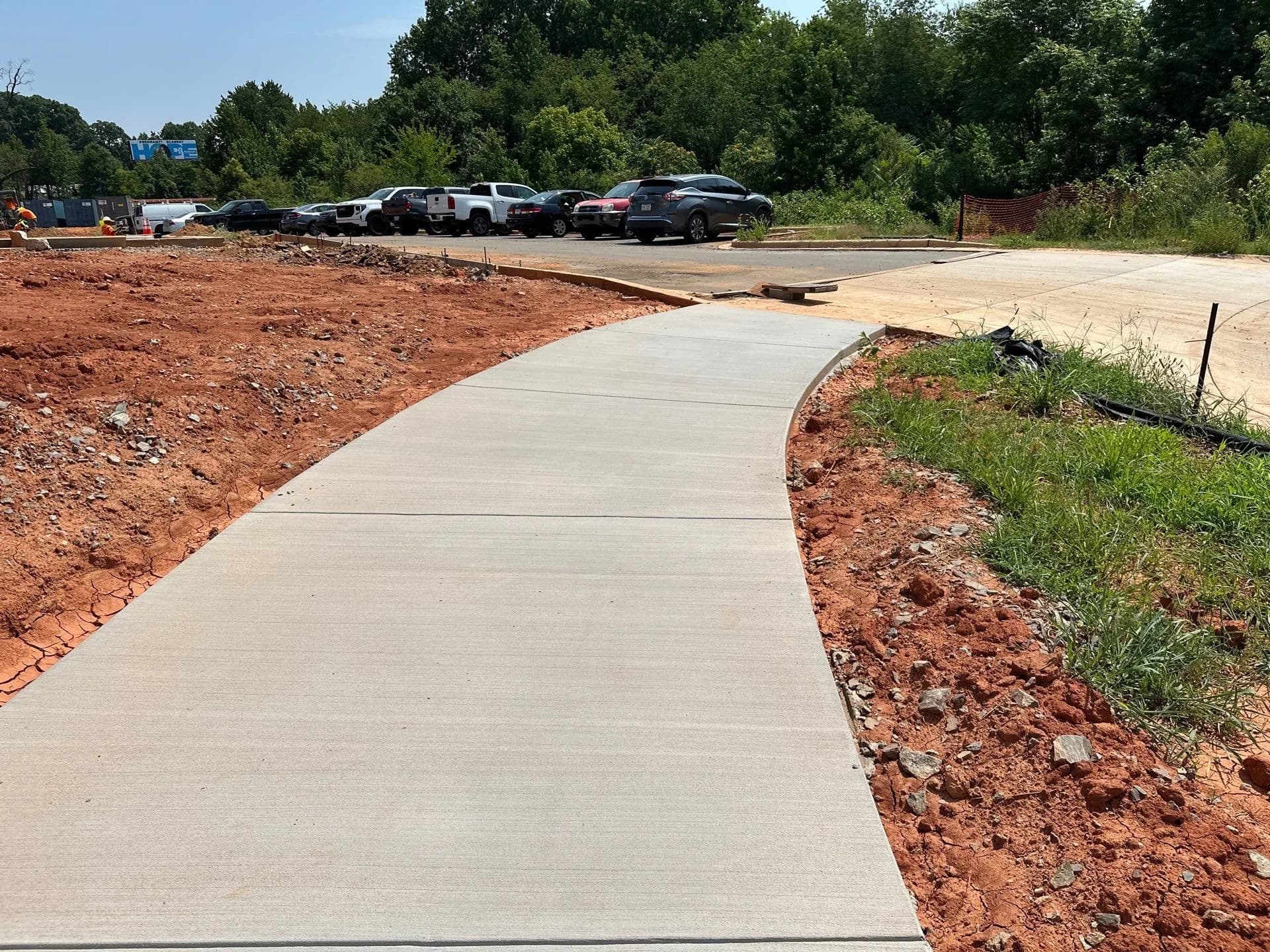 New sidewalk following a curved curb line at a commercial site