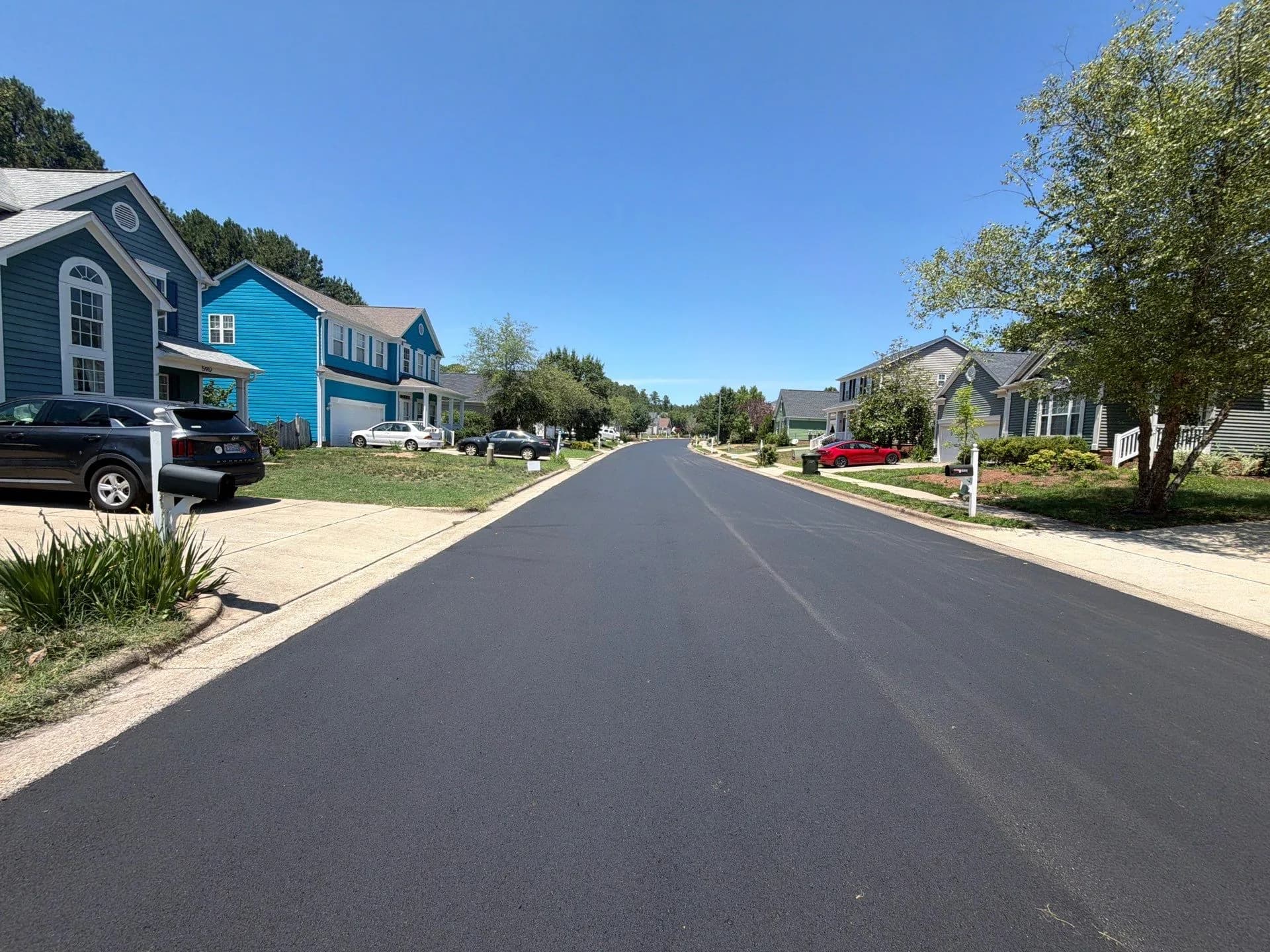 Freshly resurfaced private street running between homes in Durham, NC